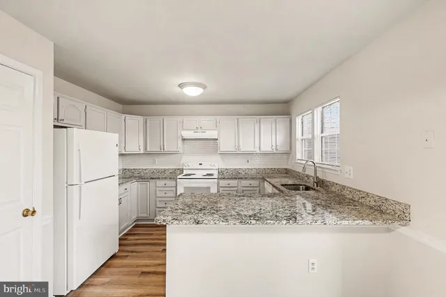 a kitchen with refrigerator and window