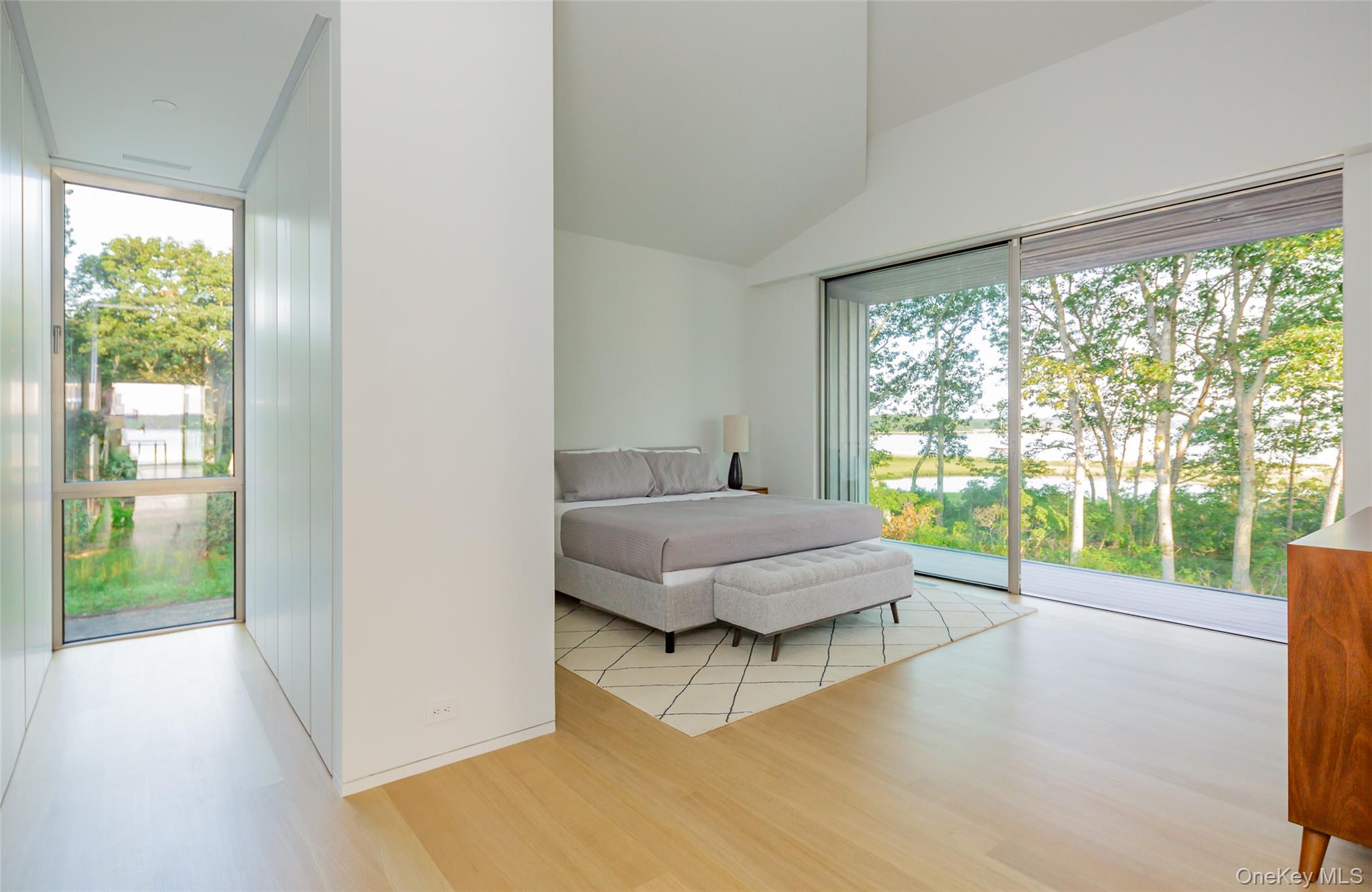 47 L South Ferry Road Shelter Island, NY 11964 - Photo 21 of 35 Bedroom featuring light wood-style flooring, access to exterior, and lofted ceiling