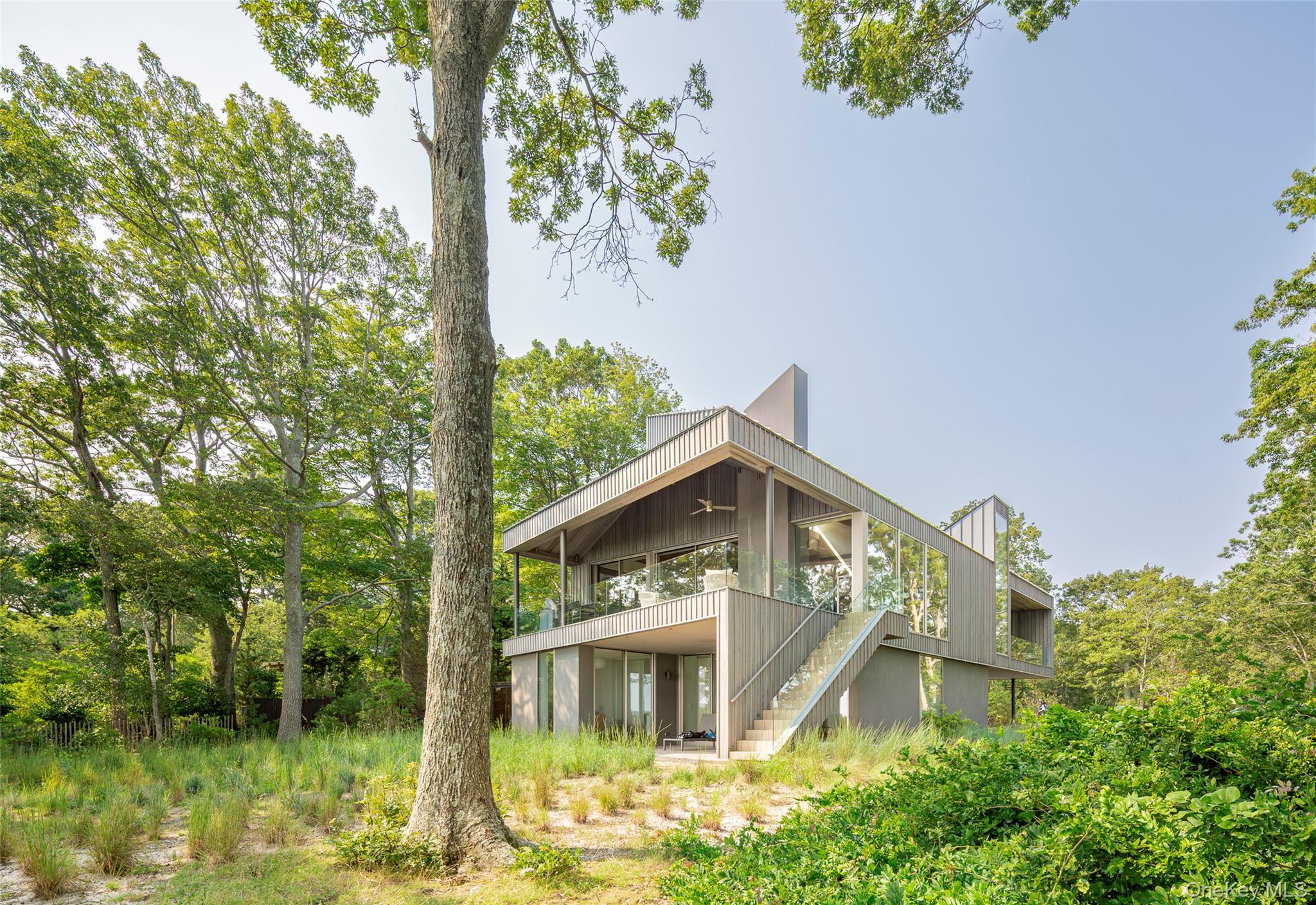 47 L South Ferry Road Shelter Island, NY 11964 - Photo 29 of 35 Back of property featuring stairs, ceiling fan, and a balcony