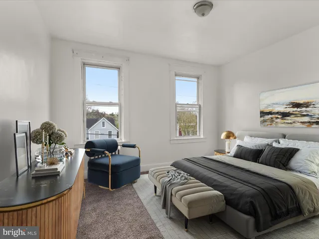 a bedroom with bed and a couch