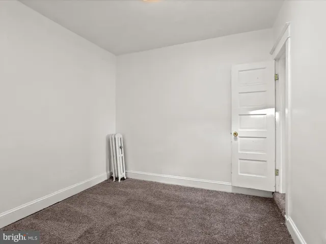 an empty room with closet and wooden floor