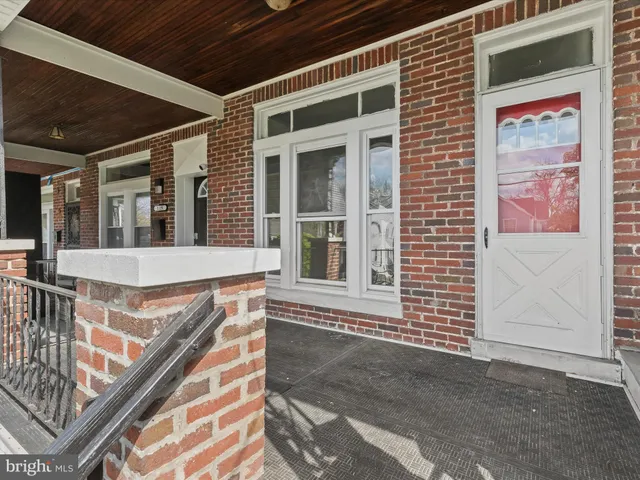 a view of a brick house with large windows