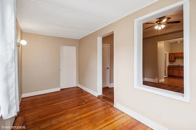 a view of a room with wooden floor and closet