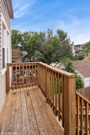 a view of balcony with wooden floor and fence