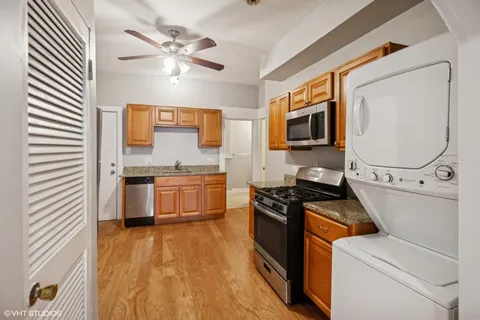 a kitchen with stainless steel appliances a stove a sink and a microwave