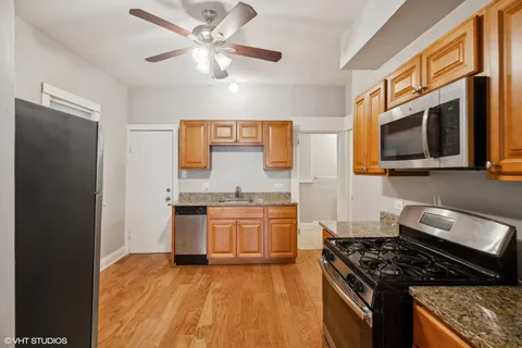 a kitchen with stainless steel appliances granite countertop a stove sink and cabinets