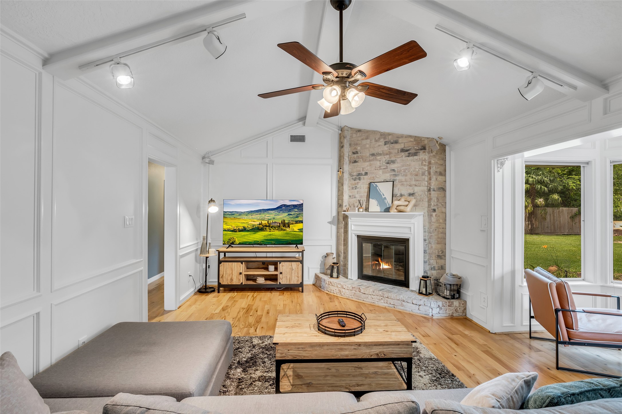 22502 Fields Lane Spring, TX 77389 - Photo 5 of 39 Sleek track lighting add a modern touch, while the space opens up to a serene view of the backyard.