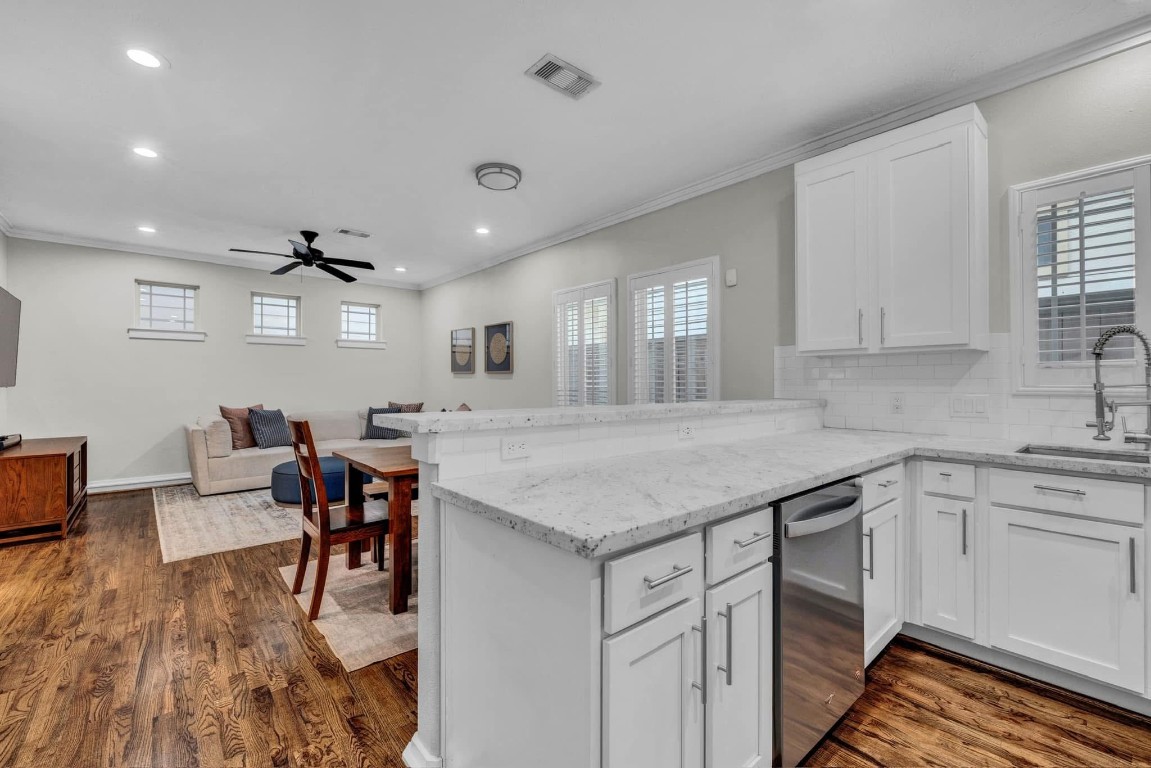 5832 Darling Street, Unit 5 Houston, TX 77007 - Photo 14 of 28 a kitchen with stainless steel appliances granite countertop a table chairs stove and white cabinets