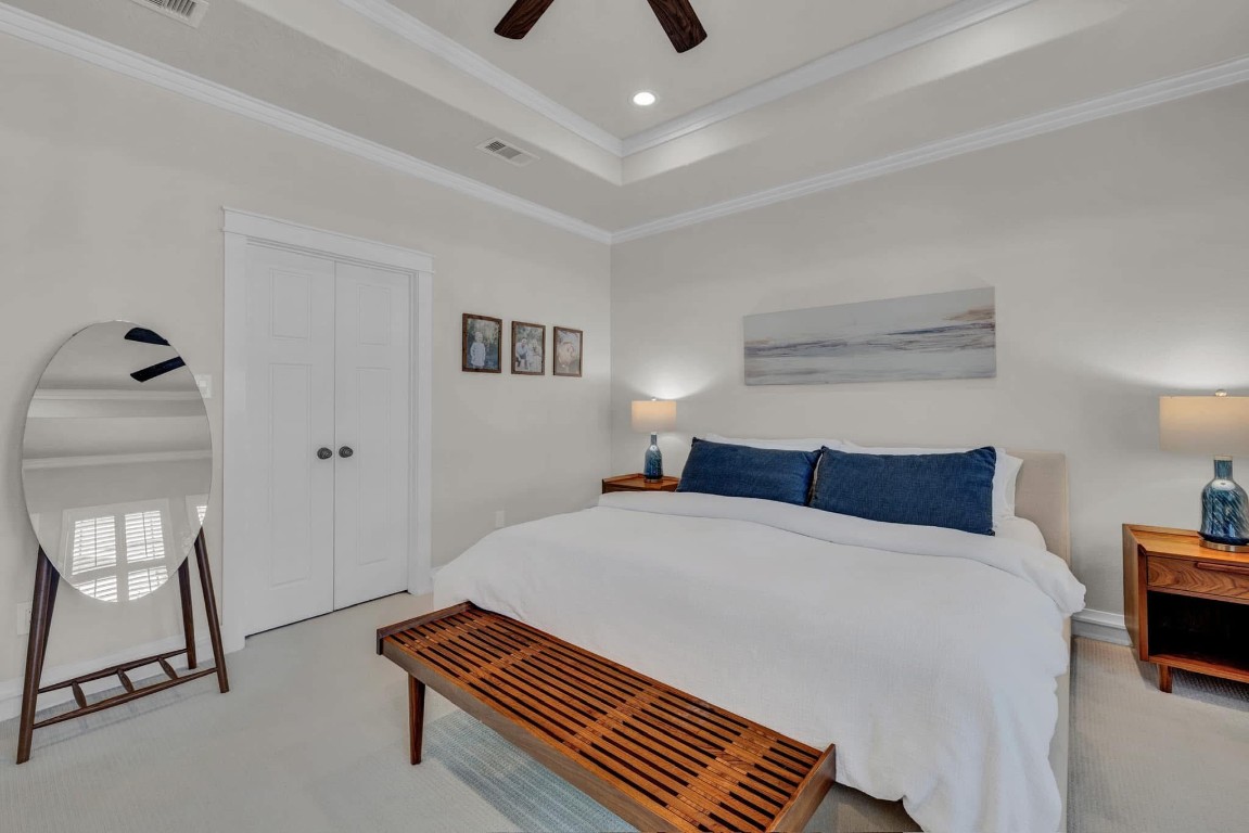 5832 Darling Street, Unit 5 Houston, TX 77007 - Photo 16 of 28 a bedroom with a bed and a chandelier