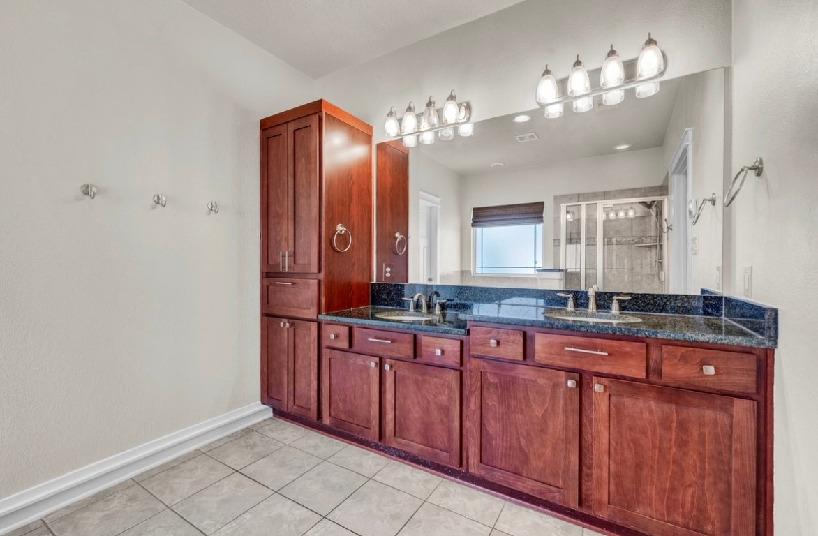 5832 Darling Street, Unit 5 Houston, TX 77007 - Photo 27 of 28 a bathroom with a double vanity sink and a mirror