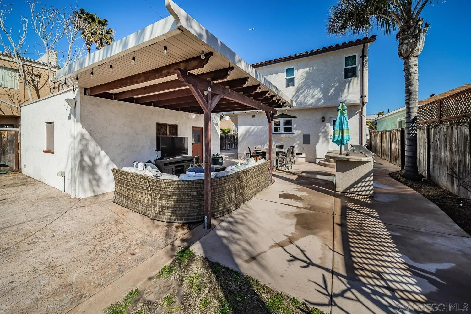 4965 Brighton Avenue Ocean Beach, CA 92107 - Photo 12 of 48 a view of a patio with table and chairs with wooden floor and fence