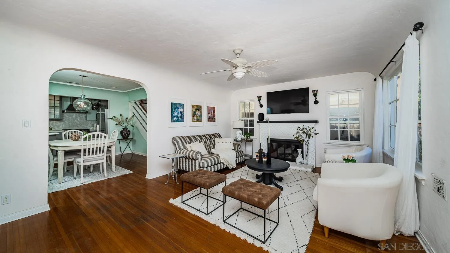 4965 Brighton Avenue Ocean Beach, CA 92107 - Photo 13 of 48 a living room with furniture a fireplace and a flat screen tv