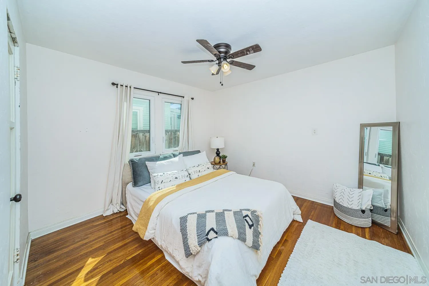 4965 Brighton Avenue Ocean Beach, CA 92107 - Photo 18 of 48 a bed sitting in a bedroom next to a window