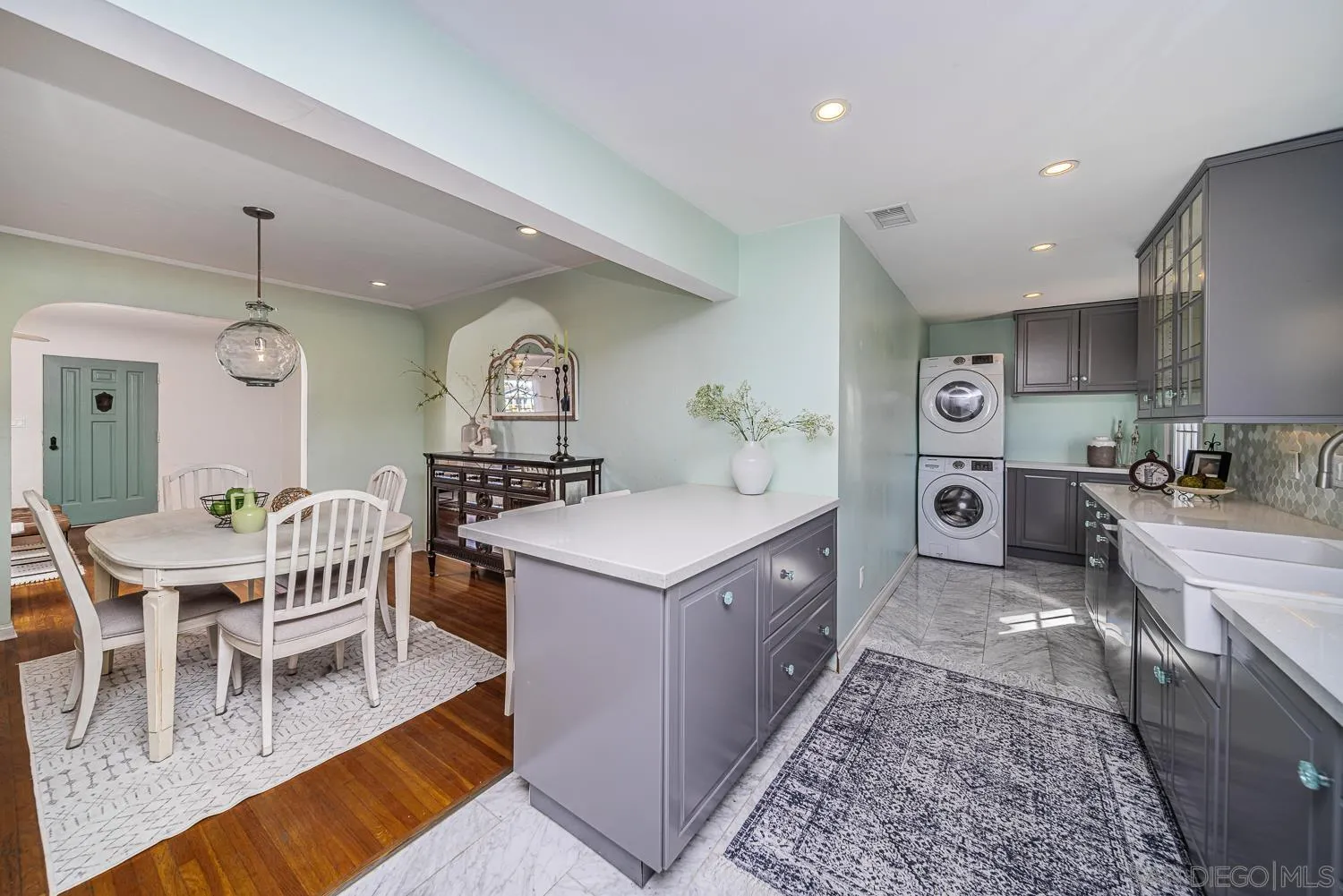 4965 Brighton Avenue Ocean Beach, CA 92107 - Photo 25 of 48 a living room with stainless steel appliances granite countertop furniture a rug kitchen view and a chandelier