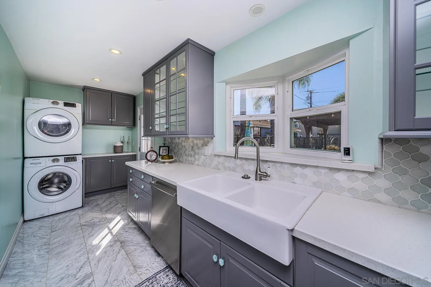 4965 Brighton Avenue Ocean Beach, CA 92107 - Photo 26 of 48 a bathroom with a sink a mirror and shower