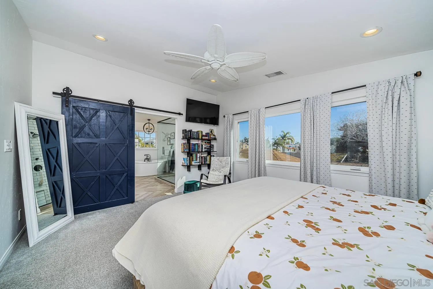4965 Brighton Avenue Ocean Beach, CA 92107 - Photo 32 of 48 a bedroom with a large bed and a large mirror