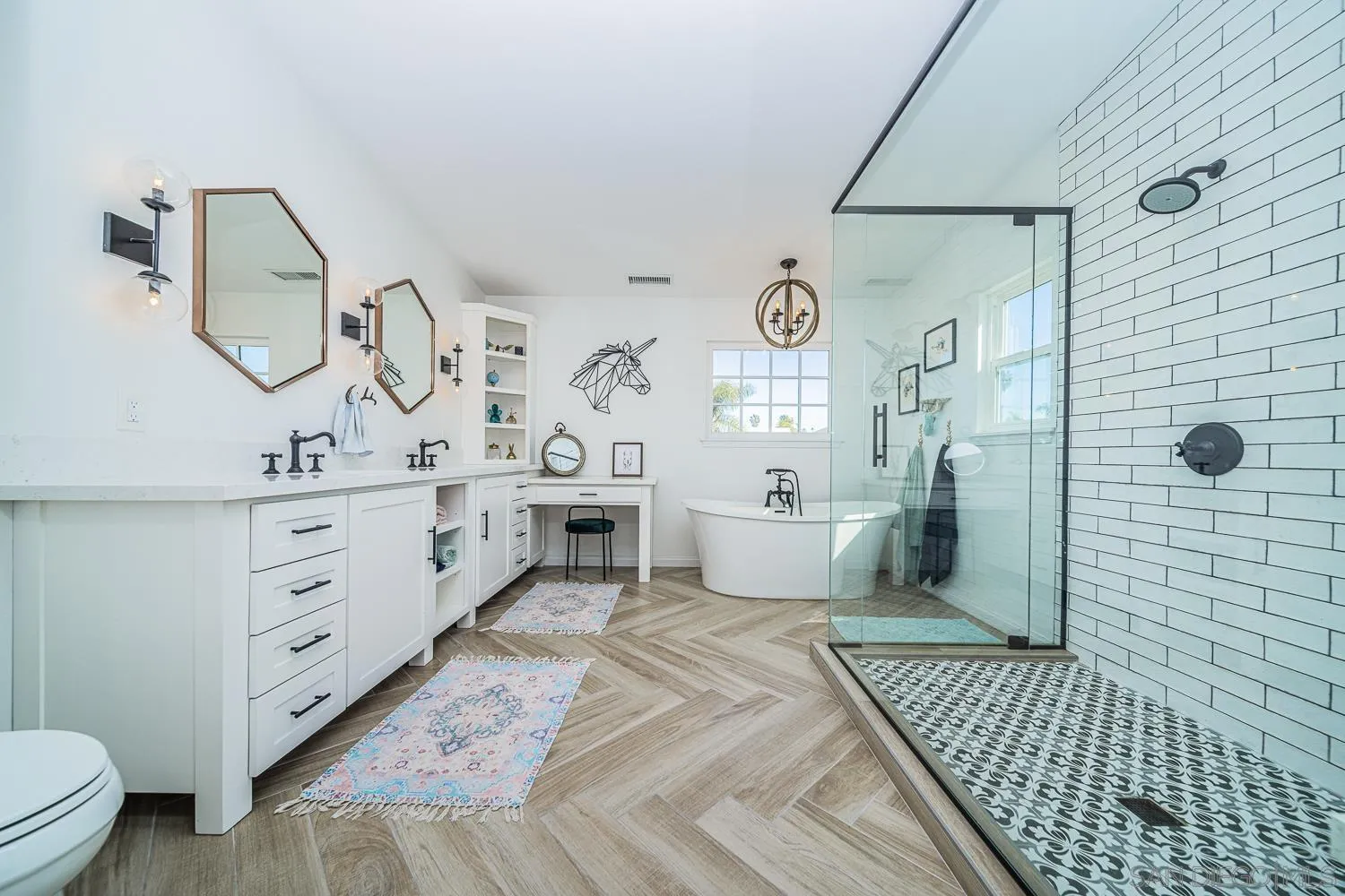 4965 Brighton Avenue Ocean Beach, CA 92107 - Photo 34 of 48 a spacious bathroom with a double vanity sink a toilet a mirror and shower