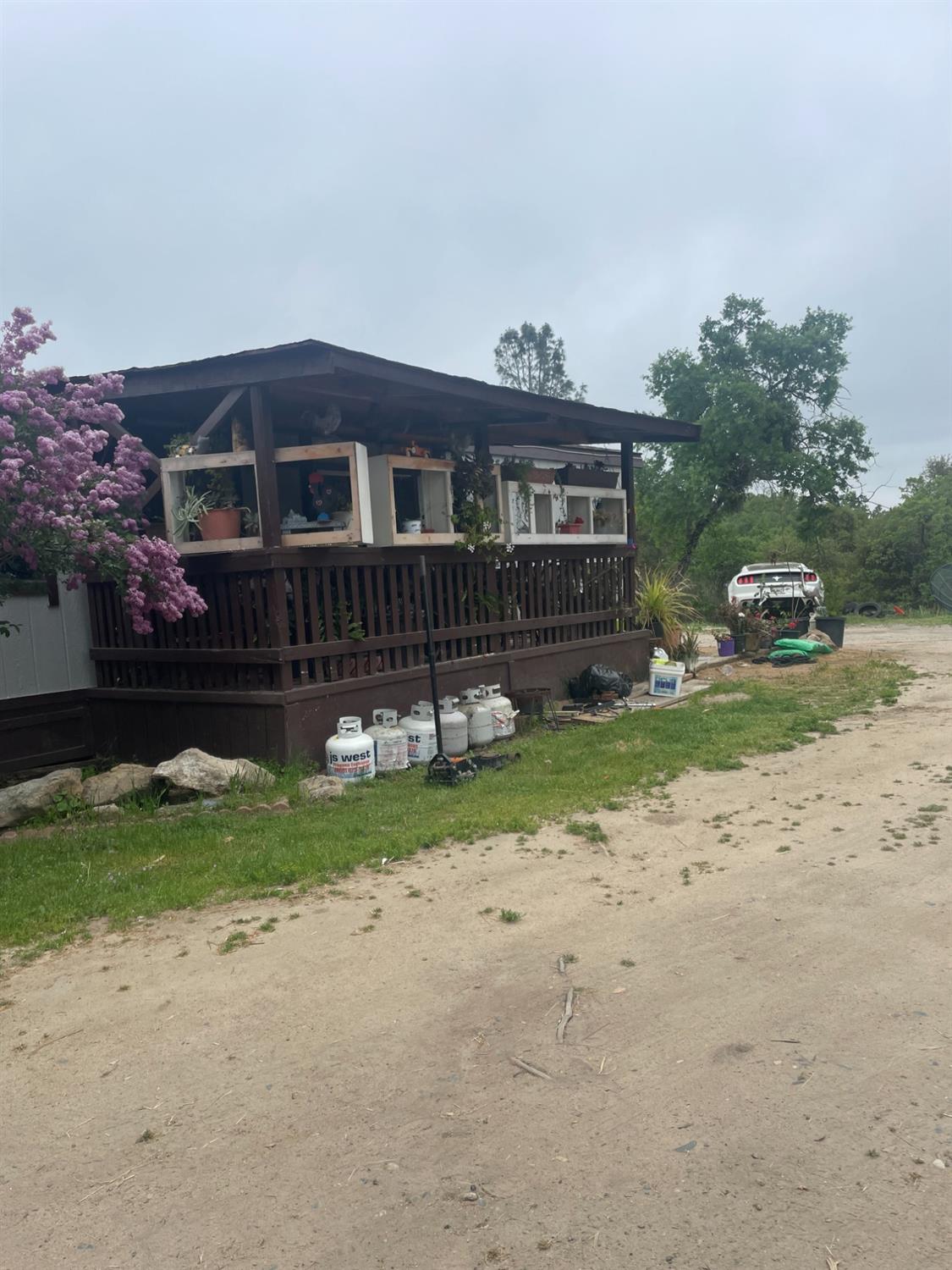 46304 Skyline Ridge Road Coarsegold, CA 93614 - Photo 8 of 12 a front view of a house with a yard and a garage