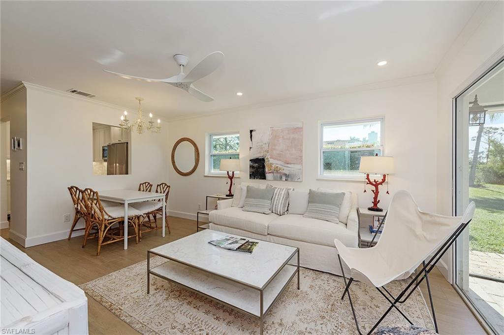 301 Ridge Drive Naples, FL 34108 - Photo 2 of 12 a living room with furniture a rug and a window