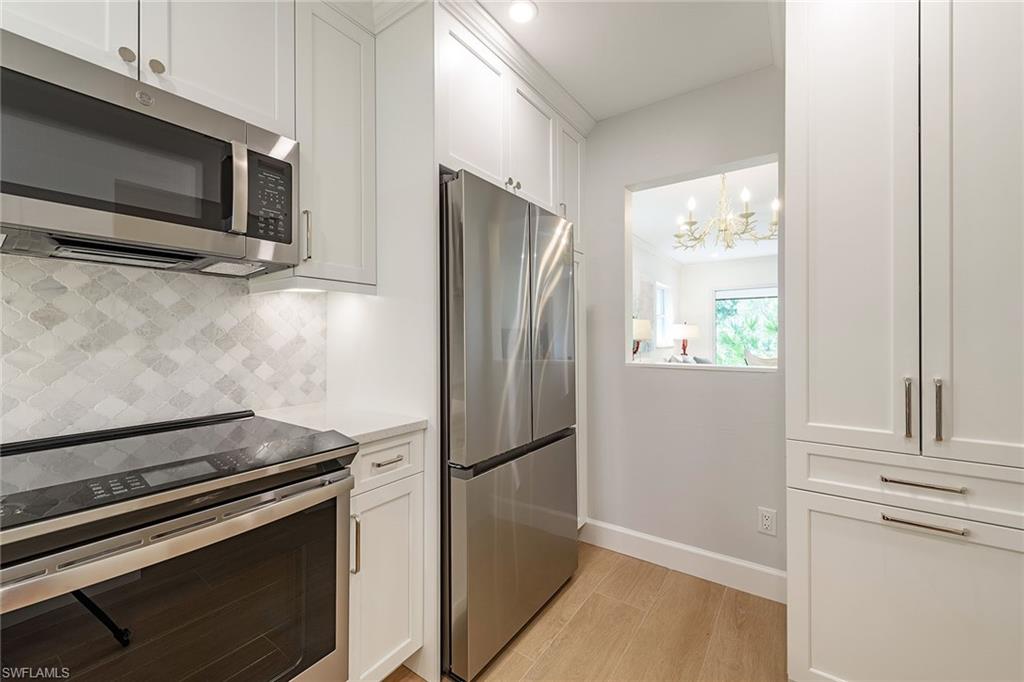 301 Ridge Drive Naples, FL 34108 - Photo 6 of 12 a kitchen with a refrigerator stove and microwave