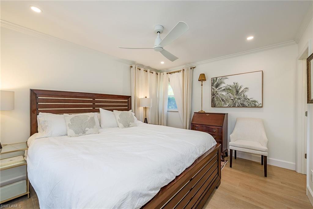 301 Ridge Drive Naples, FL 34108 - Photo 7 of 12 a bedroom with a bed and a chandelier
