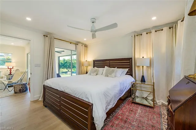 a bedroom with a bed and large window