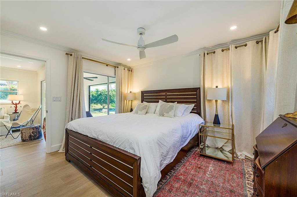 301 Ridge Drive Naples, FL 34108 - Photo 8 of 12 a bedroom with a bed and large window