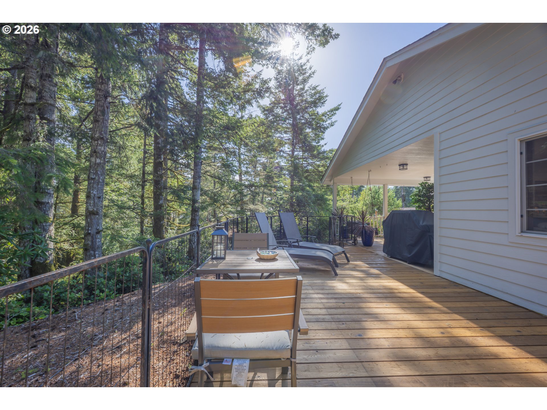 2193 13th Street Florence, OR 97439 - Photo 32 of 48 a view of a patio with table and chairs with wooden fence