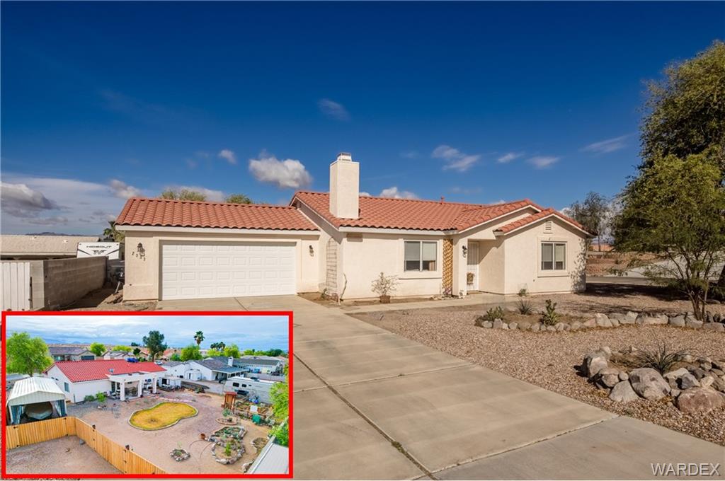 2333 Primavera Loop Fort Mohave, AZ 86426 - Photo 1 of 57 a front view of a house with a yard