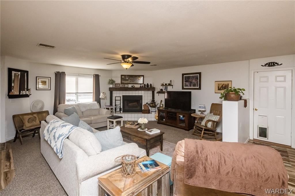 2333 Primavera Loop Fort Mohave, AZ 86426 - Photo 11 of 57 a living room with furniture a fireplace and a flat screen tv