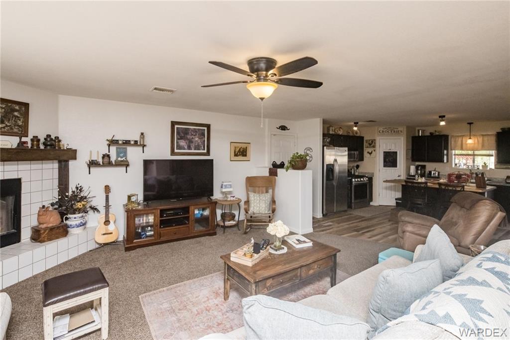 2333 Primavera Loop Fort Mohave, AZ 86426 - Photo 14 of 57 a living room with furniture and a flat screen tv with kitchen view