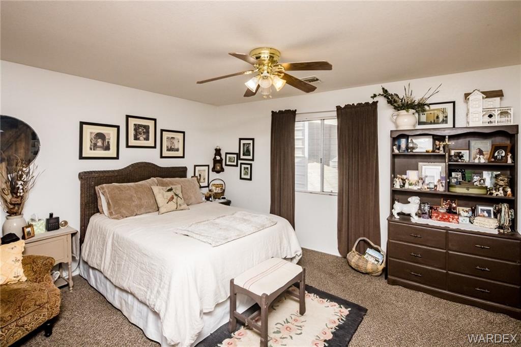 2333 Primavera Loop Fort Mohave, AZ 86426 - Photo 22 of 57 a spacious bedroom with a bed and cabinets