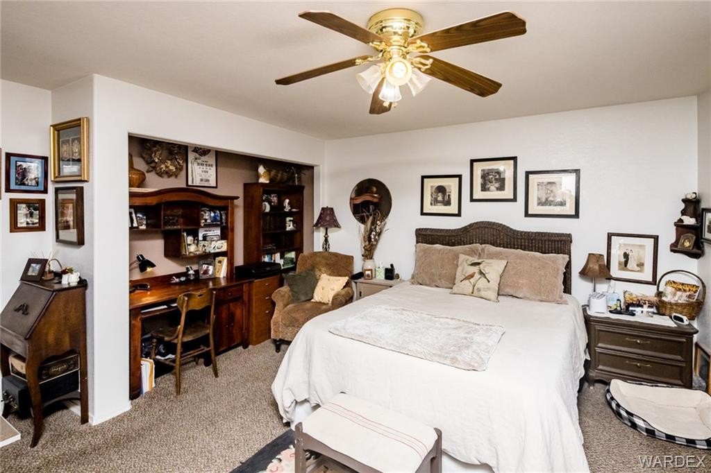 2333 Primavera Loop Fort Mohave, AZ 86426 - Photo 23 of 57 a bedroom with a bed and a chandelier