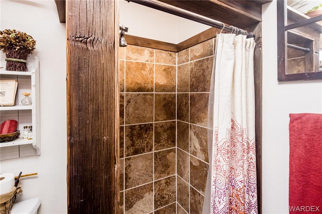 2333 Primavera Loop Fort Mohave, AZ 86426 - Photo 26 of 57 a bathroom with a shower and a glass door