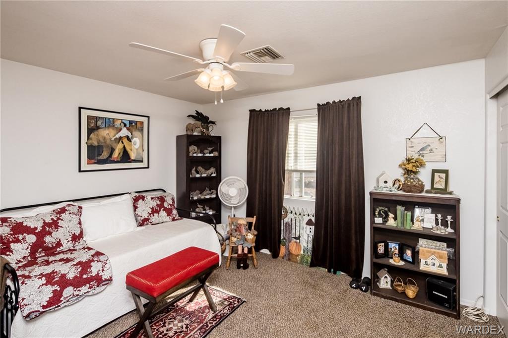 2333 Primavera Loop Fort Mohave, AZ 86426 - Photo 28 of 57 a bedroom with furniture and a book shelf