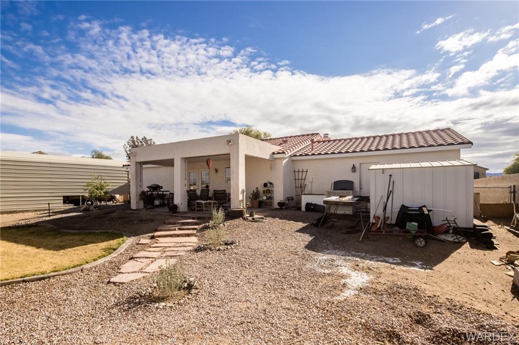 2333 Primavera Loop Fort Mohave, AZ 86426 - Photo 35 of 57 a view of a patio with a table and chairs under an umbrella