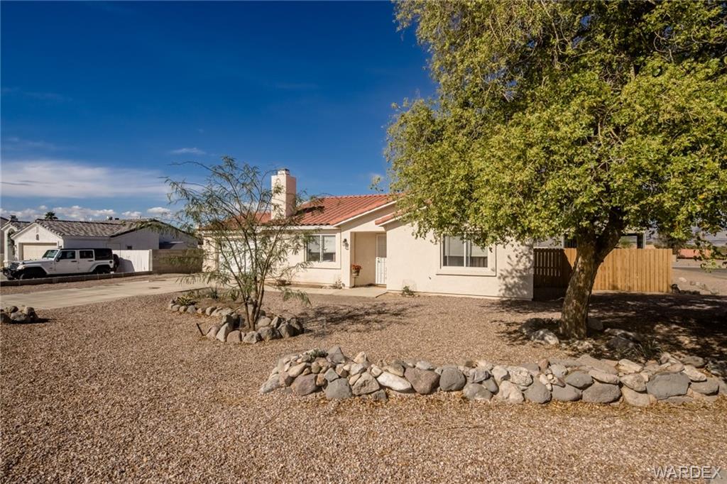 2333 Primavera Loop Fort Mohave, AZ 86426 - Photo 5 of 57 a view of a backyard with table and chairs and potted plants
