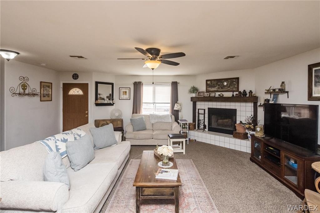 2333 Primavera Loop Fort Mohave, AZ 86426 - Photo 9 of 57 a living room with furniture a flat screen tv and a fireplace