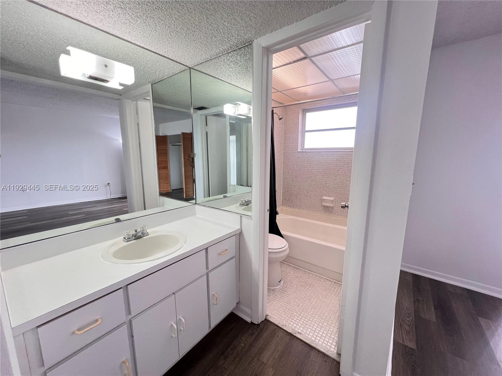 1855 West 60th Street, Unit 430 Hialeah, FL 33012 - Photo 11 of 16 a bathroom with a sink a toilet and shower