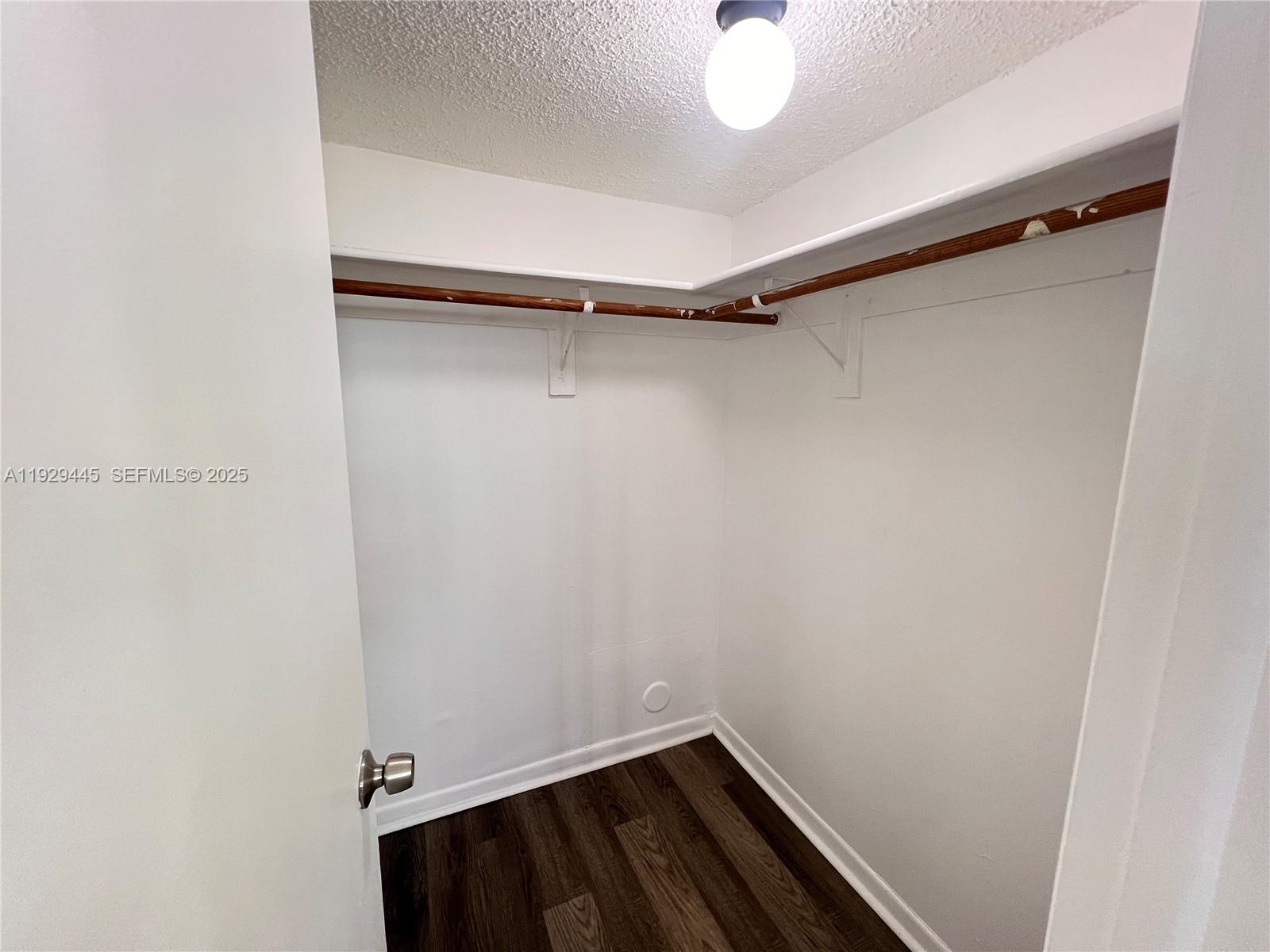 1855 West 60th Street, Unit 430 Hialeah, FL 33012 - Photo 14 of 16 a view of a room with racks on the wall