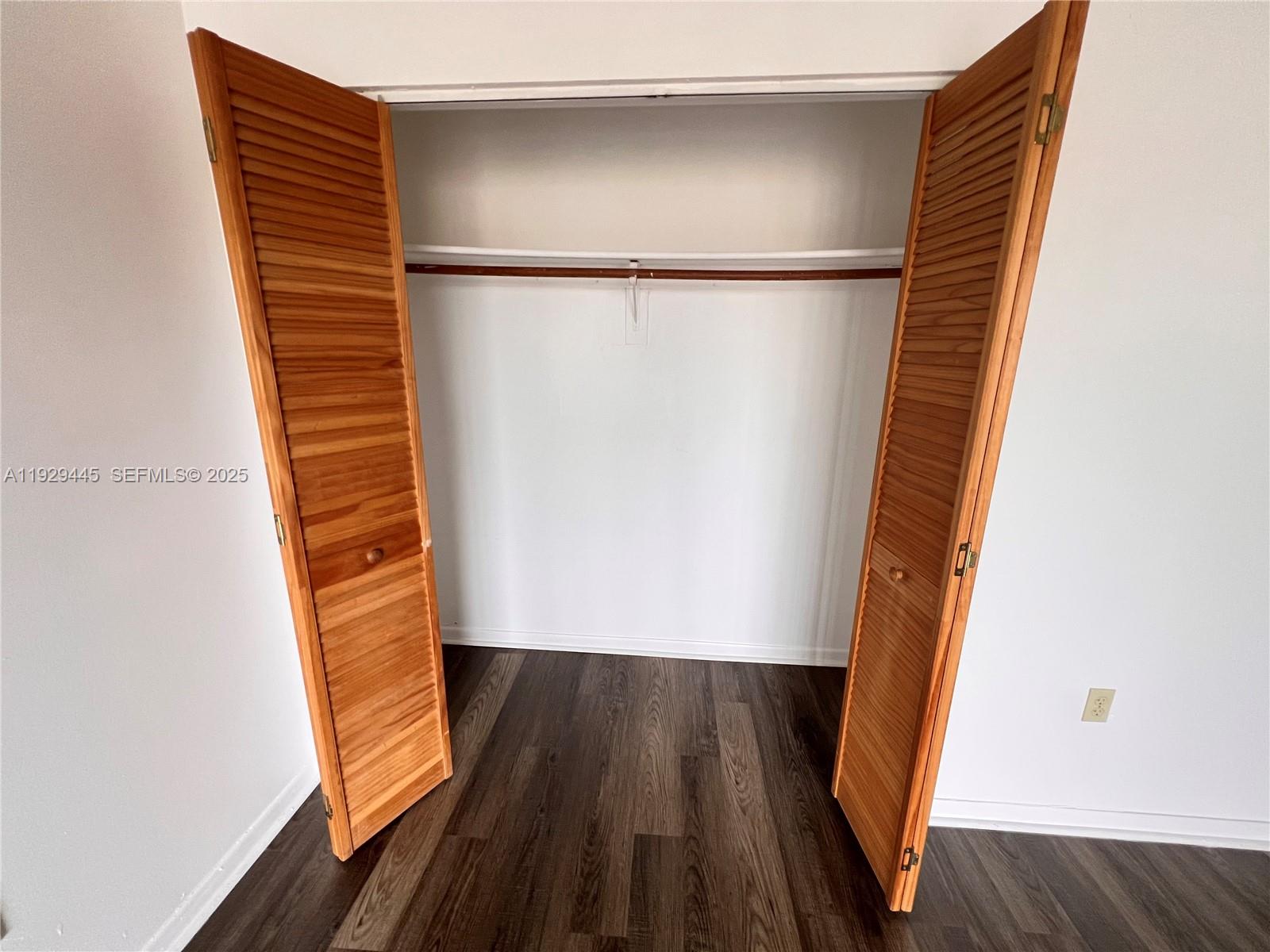 1855 West 60th Street, Unit 430 Hialeah, FL 33012 - Photo 15 of 16 a view of walk in closet with wooden floor