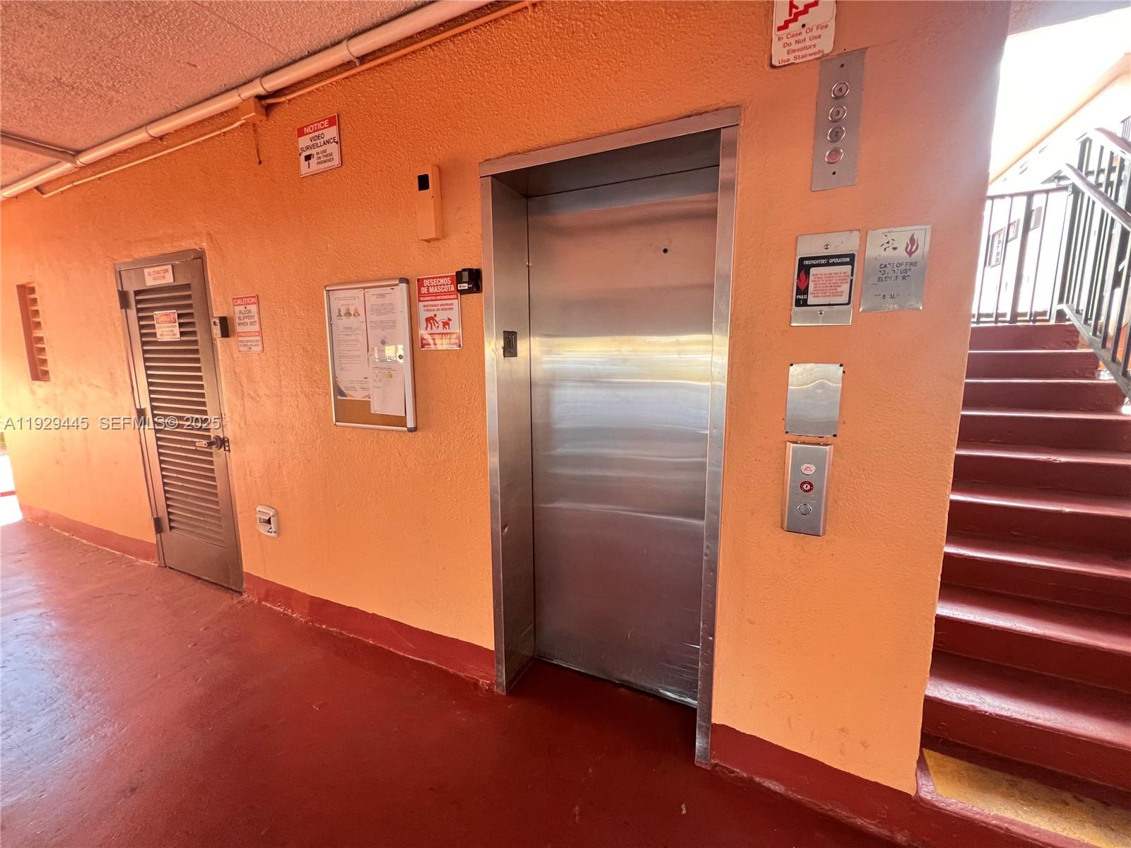 1855 West 60th Street, Unit 430 Hialeah, FL 33012 - Photo 3 of 16 an empty room with wooden floor and windows