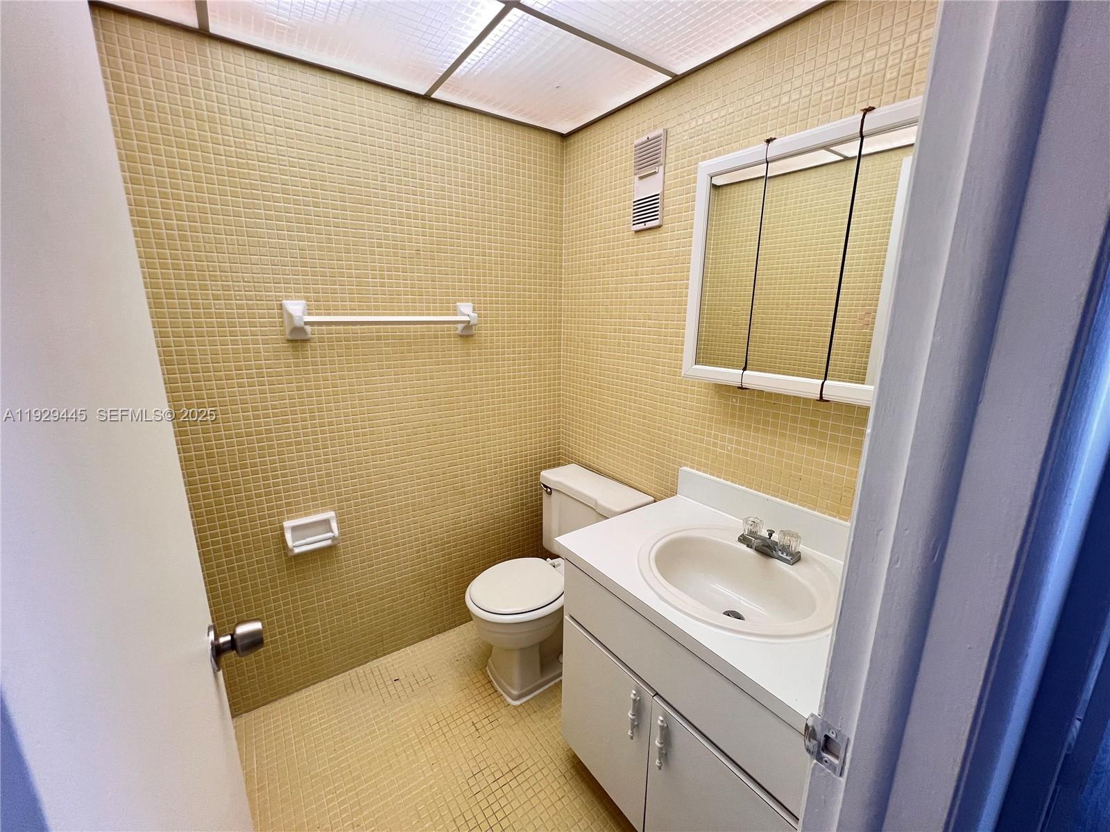 1855 West 60th Street, Unit 430 Hialeah, FL 33012 - Photo 8 of 16 a bathroom with a sink a toilet and shower