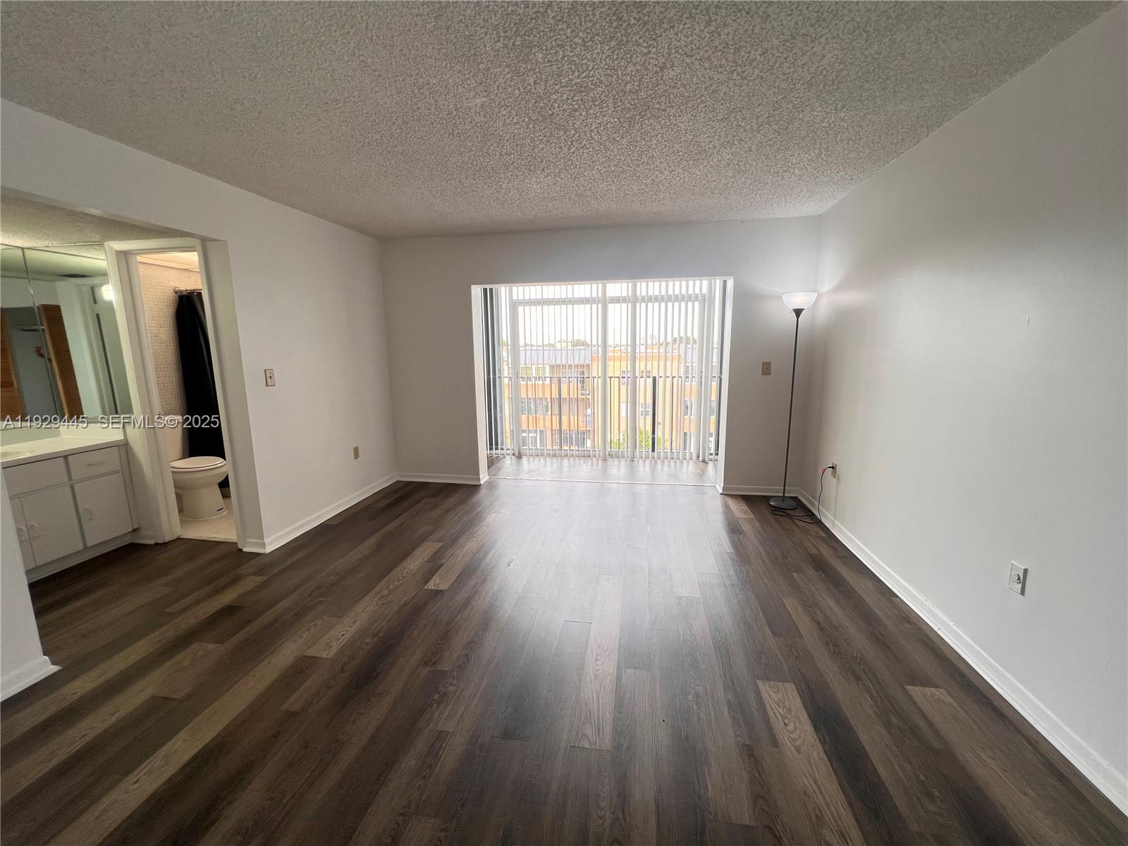 1855 West 60th Street, Unit 430 Hialeah, FL 33012 - Photo 9 of 16 a view of a room with wooden floor and electronic appliances