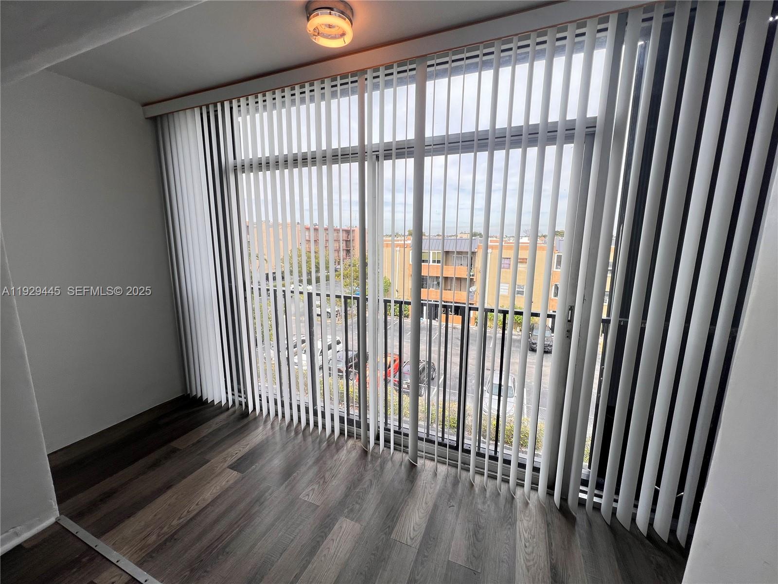 1855 West 60th Street, Unit 430 Hialeah, FL 33012 - Photo 10 of 16 a view of a balcony with wooden floor