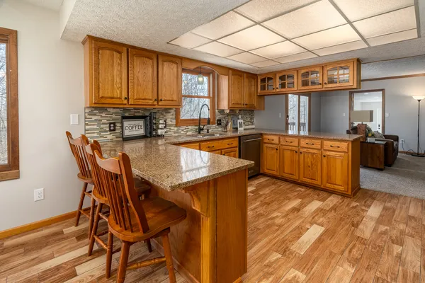 a bathroom with a granite countertop toilet sink and mirror