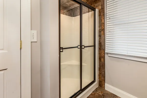 an empty room with closet and a chandelier fan