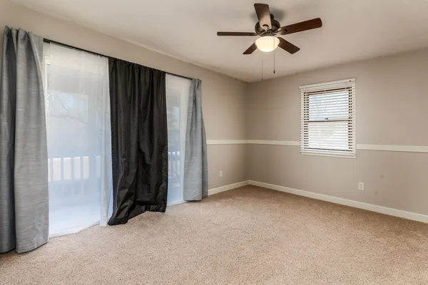 a view of an empty room with a staircase
