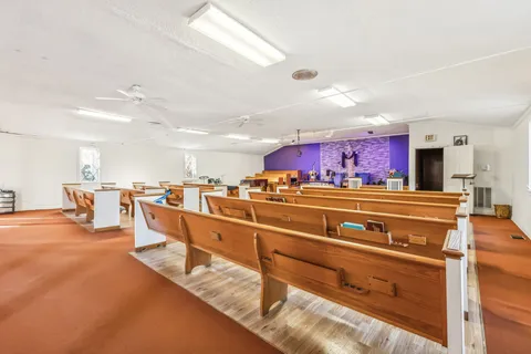 a room with gym equipment and view of kitchen