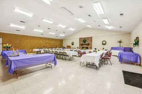 a living room with lots of furniture and view of kitchen